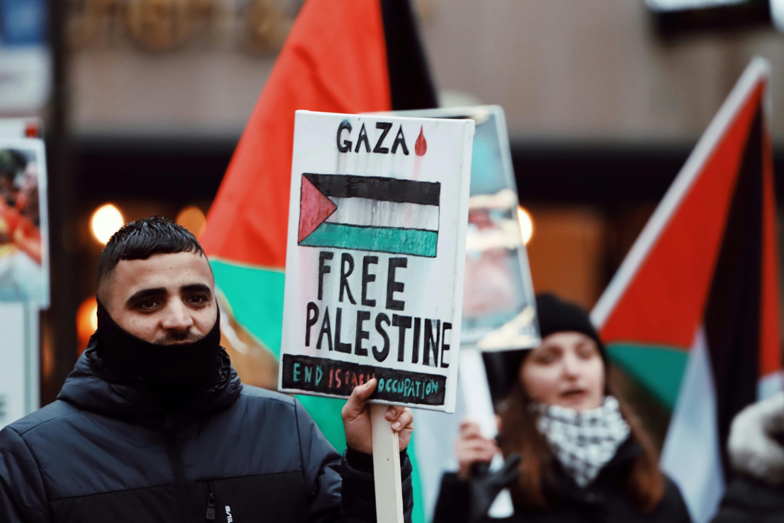 Demonstrators hold signs and flags at a Free Palestine protest in Jönköping, Sweden.